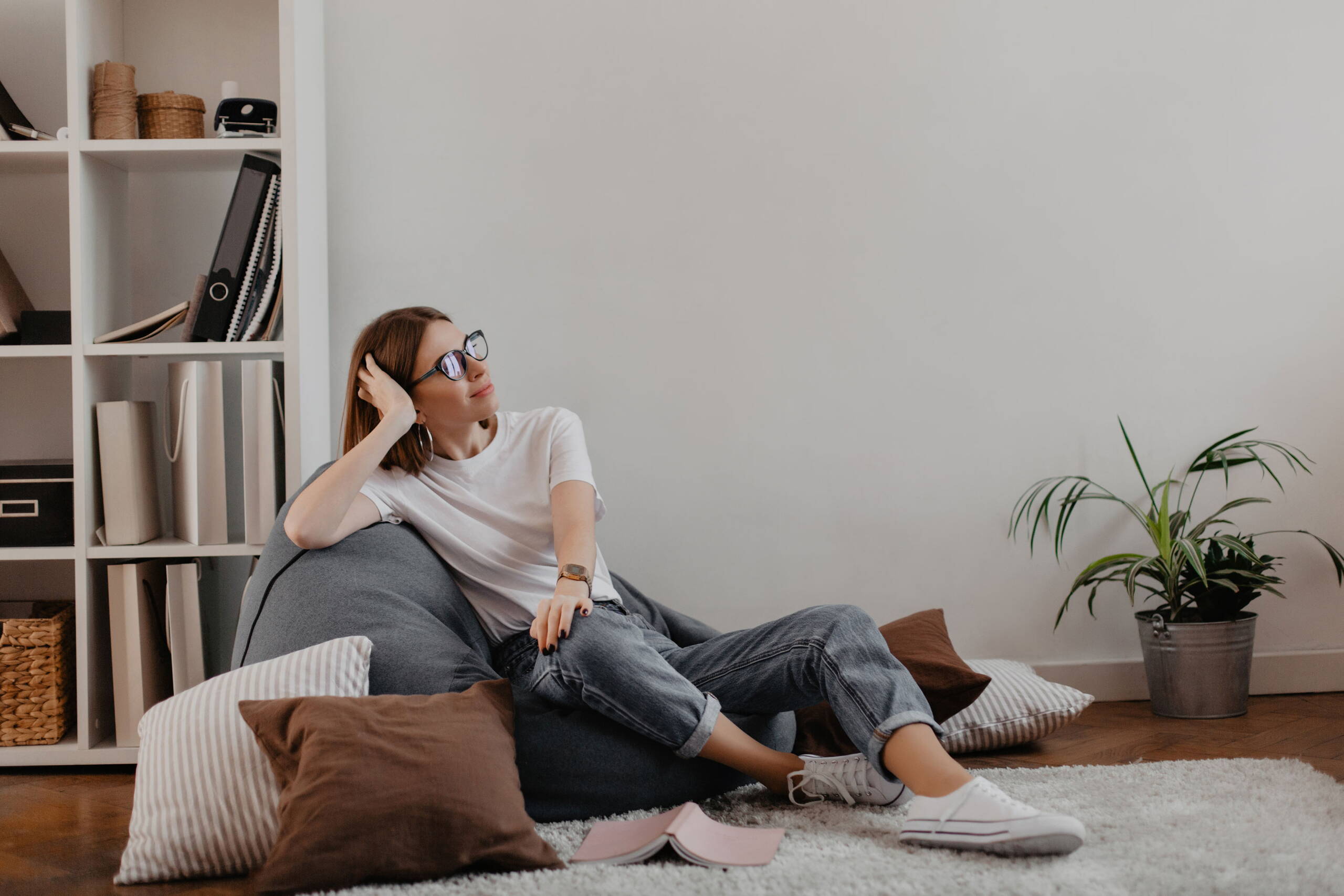 satisfied-woman-jeans-t-shirt-relaxed-sitting-bag-chair-against-shelf-with-folders.jpg satisfied-woman-jeans-t-shirt-relaxed-sitting-bag-chair-against-shelf-with-folders.jpg