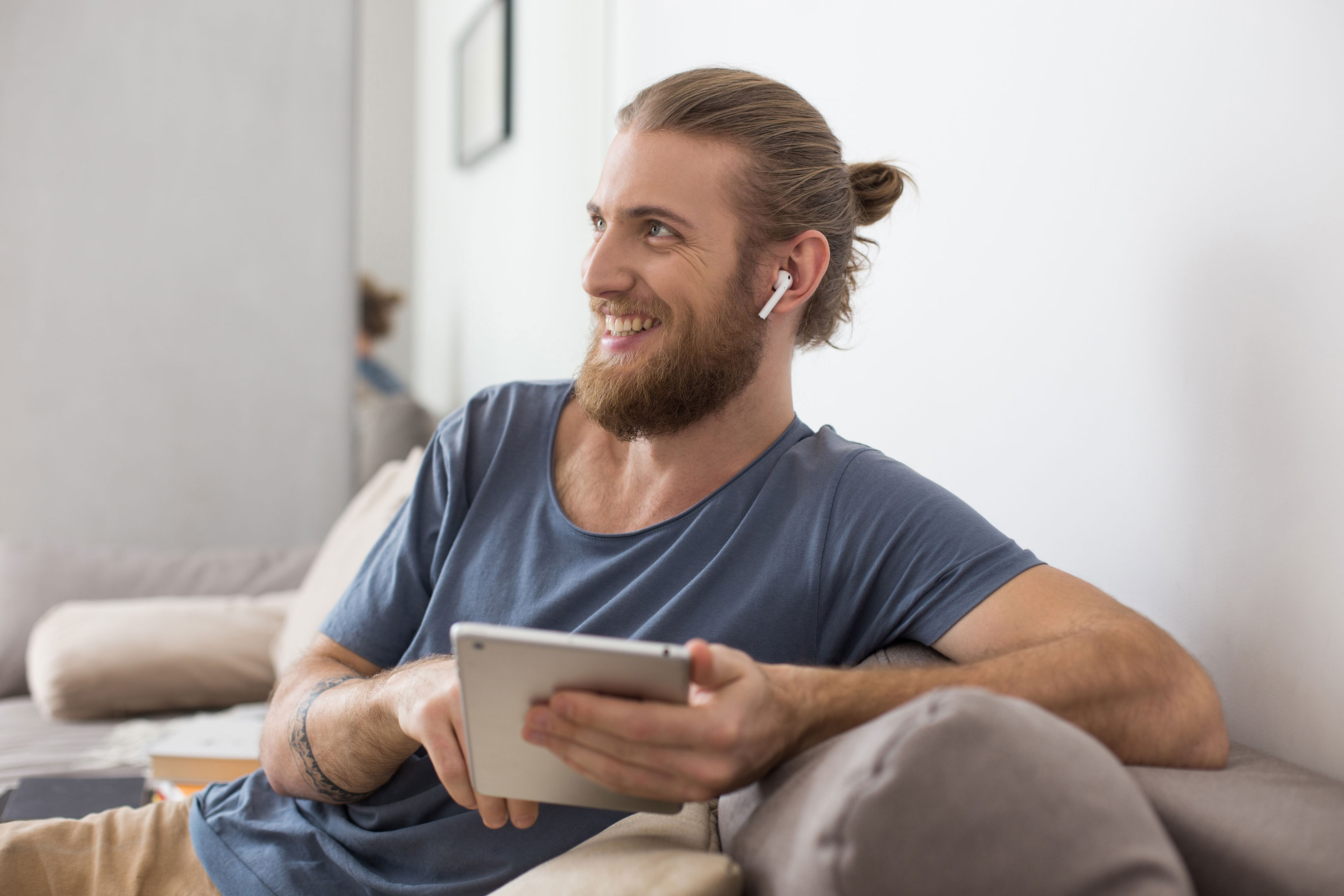 portrait-young-man-sitting-gray-sofa-with-earphones-tablet-hands-happily-looking-aside-home.jpg portrait-young-man-sitting-gray-sofa-with-earphones-tablet-hands-happily-looking-aside-home